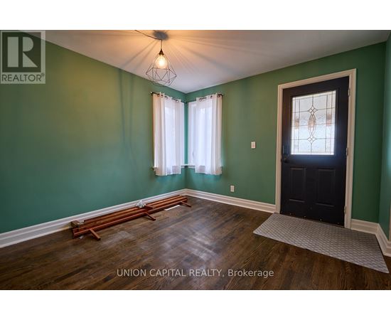 A room with green walls and a black door.