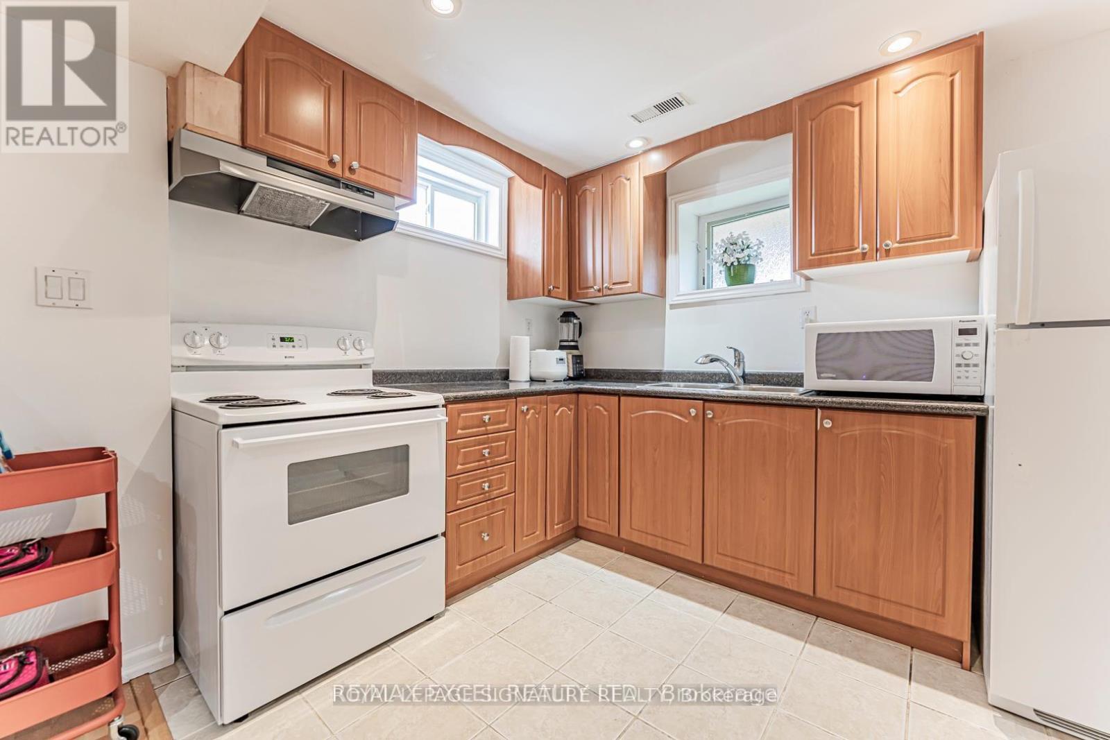 A kitchen with wooden cabinets and white appliances.
