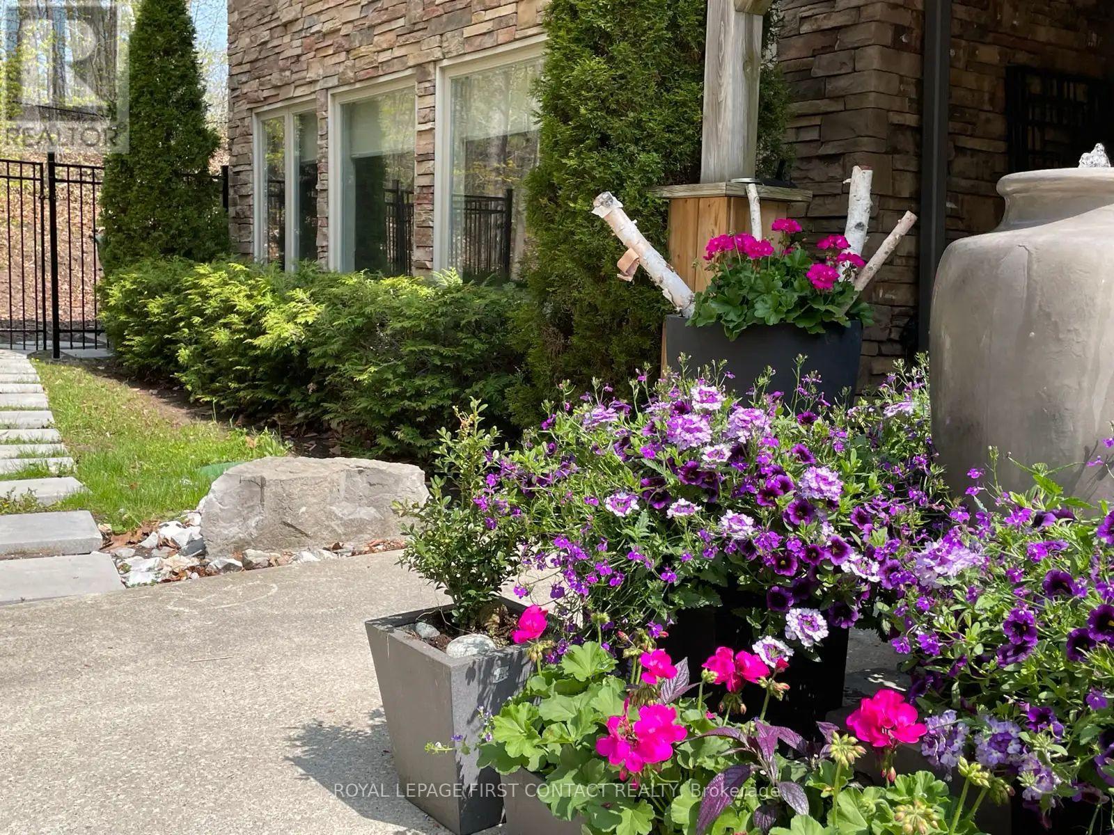 A flower box is on the right of a driveway.