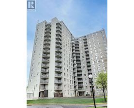 A tall residential building with balconies on each floor.