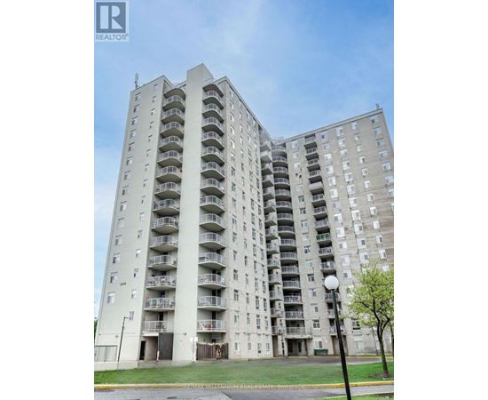 A tall residential building with balconies on each floor.