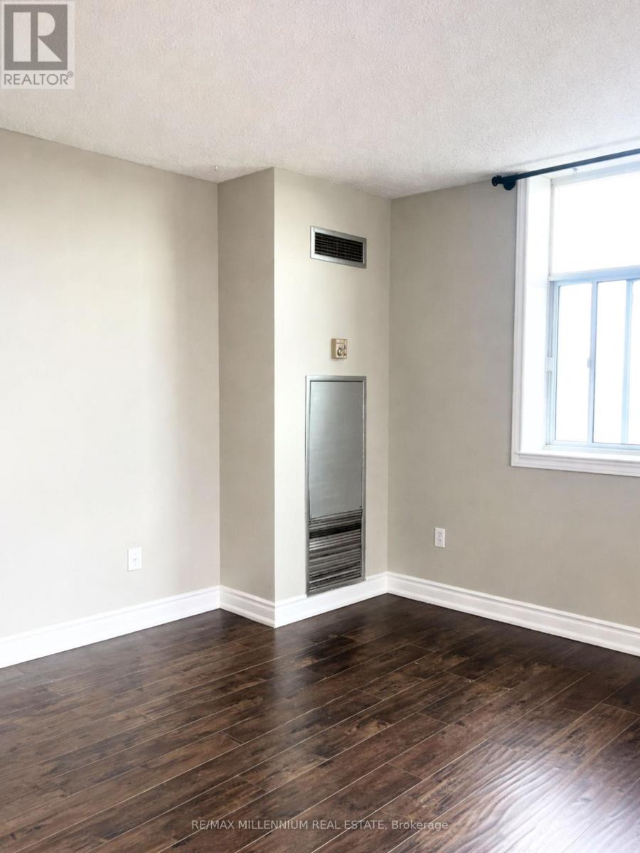 A room with a wood floor and a window.