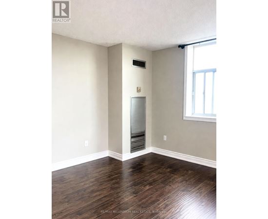 A room with a wood floor and a window.
