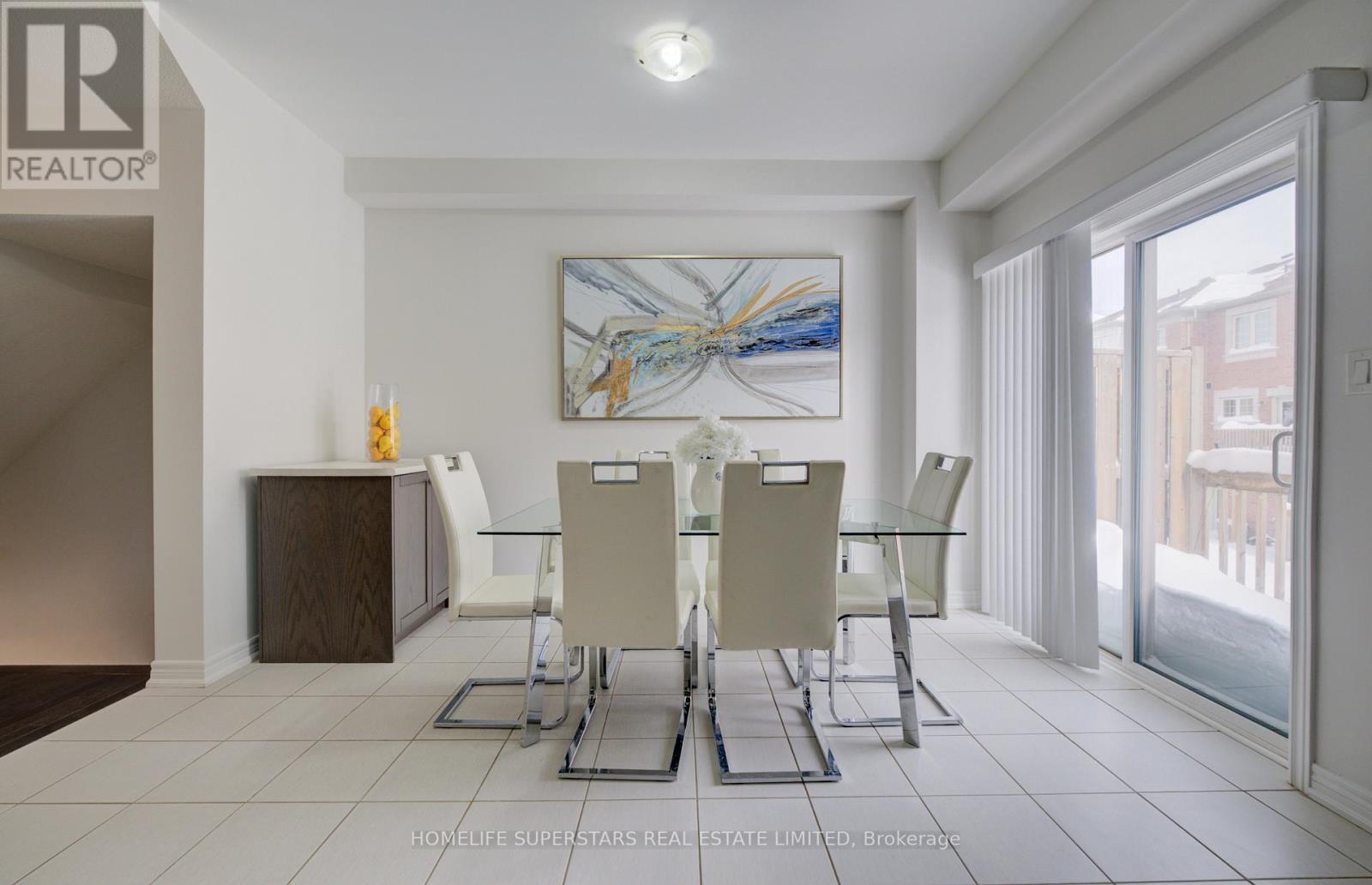 A dining room with a glass table and chairs.