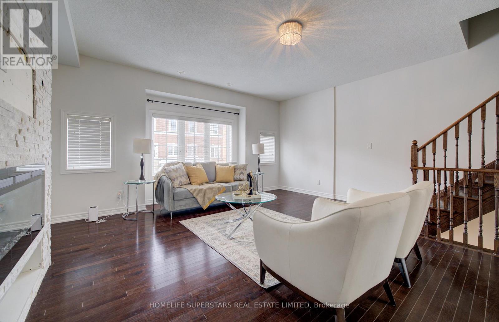 A living room with a white couch and a glass table.