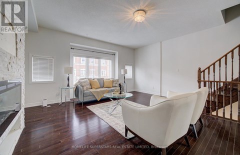 A living room with a white couch and a glass table.
