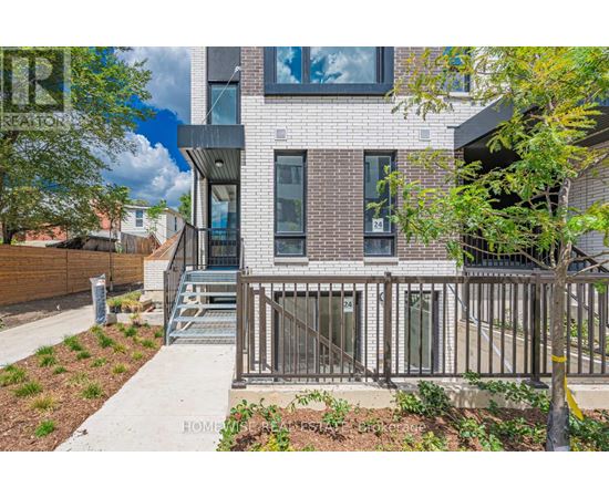 A modern house with a brick facade and a metal railing.
