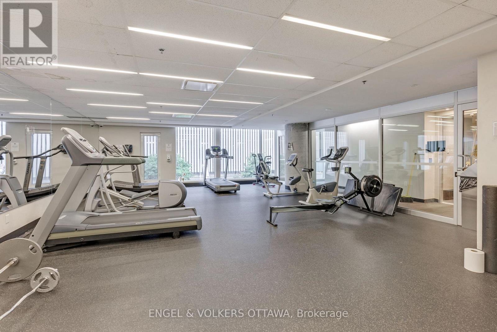A gym with treadmills, elliptical machines, and other exercise equipment.