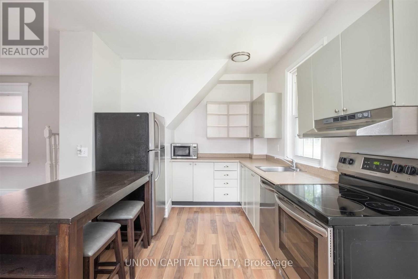 A kitchen with a stove top oven and a microwave.
