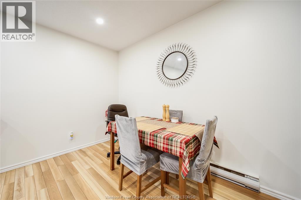 A dining room with a table and chairs.