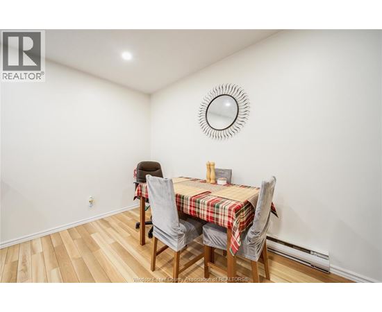 A dining room with a table and chairs.