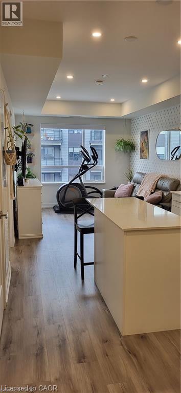 A modern kitchen with a large island and a view of the city.