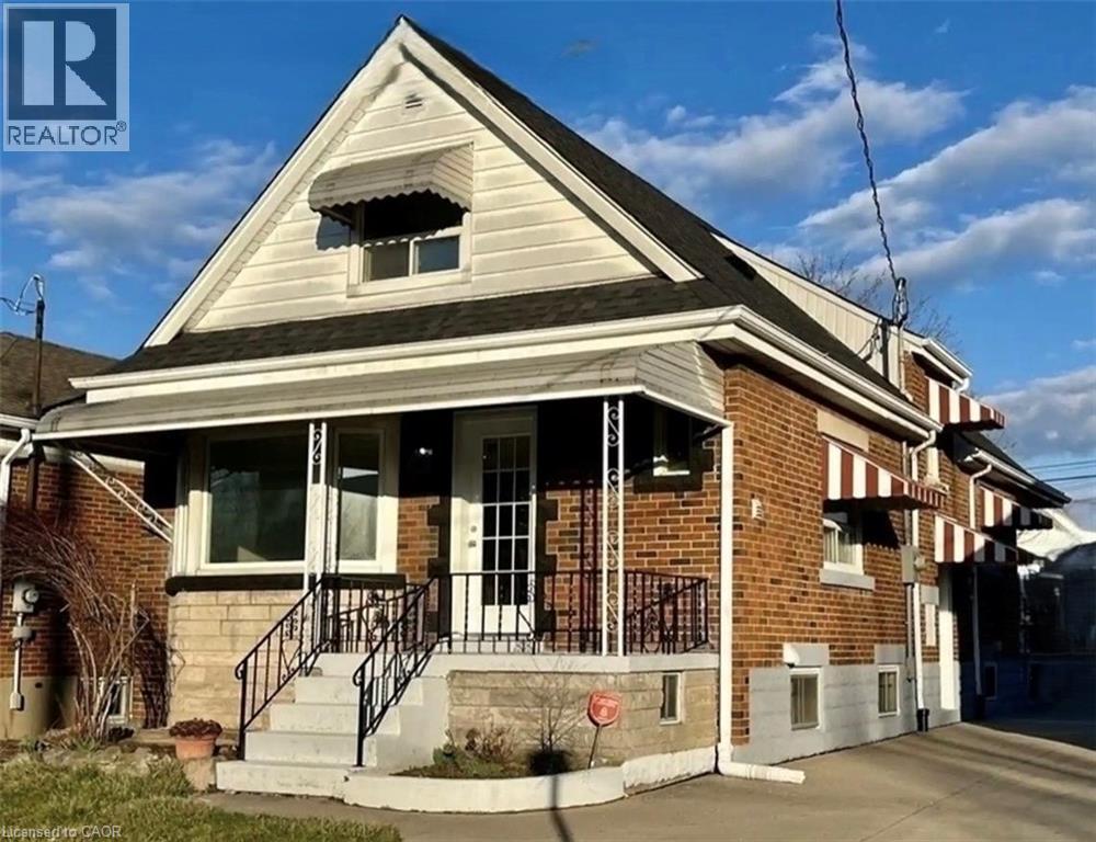 A house with a brick facade and a porch with a railing.