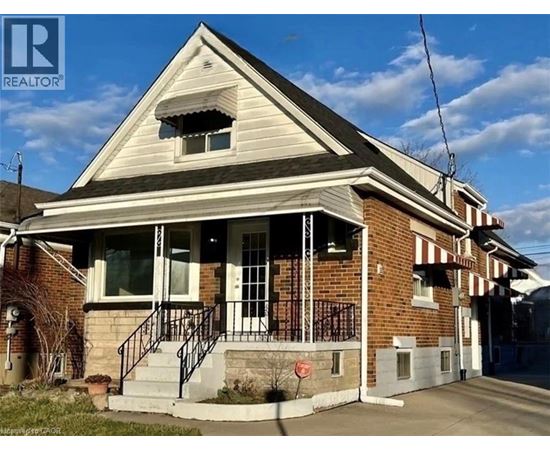 A house with a brick facade and a porch with a railing.