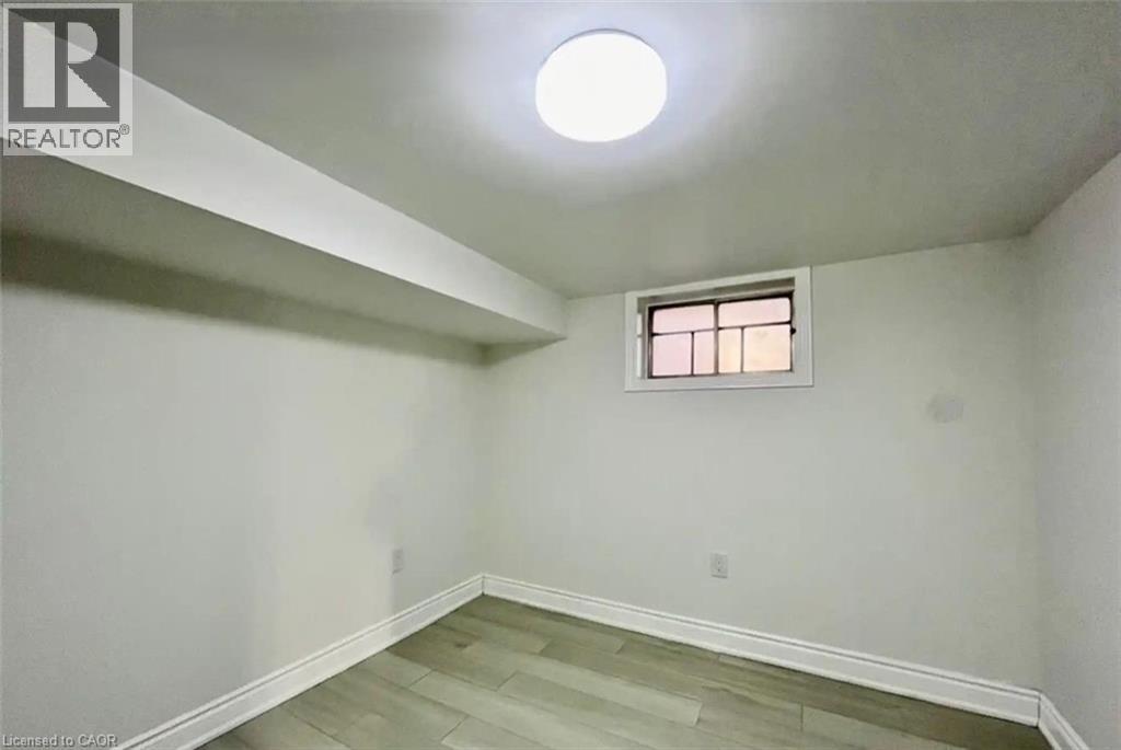 A room with a window and a light on the ceiling.