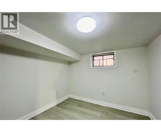 A room with a window and a light on the ceiling.