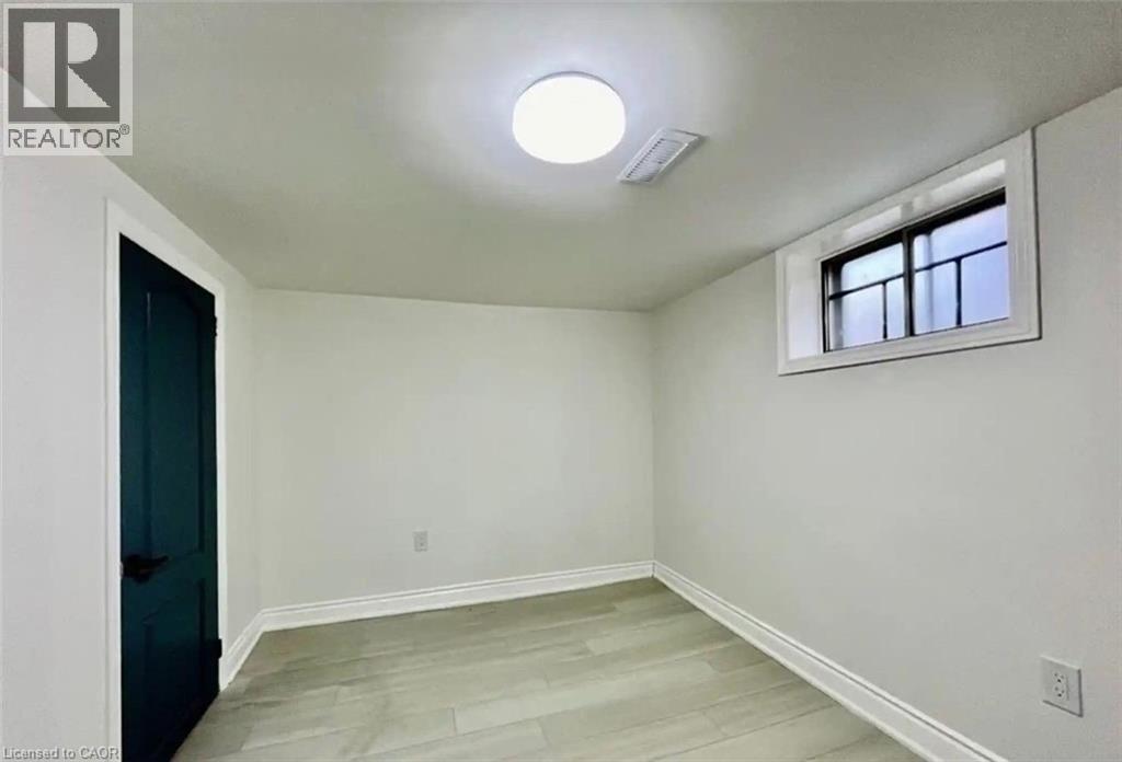 A room with a window and a light on the ceiling.