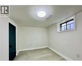 A room with a window and a light on the ceiling.