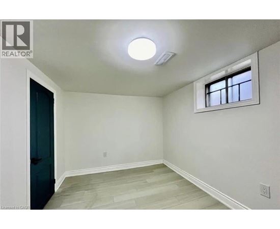 A room with a window and a light on the ceiling.