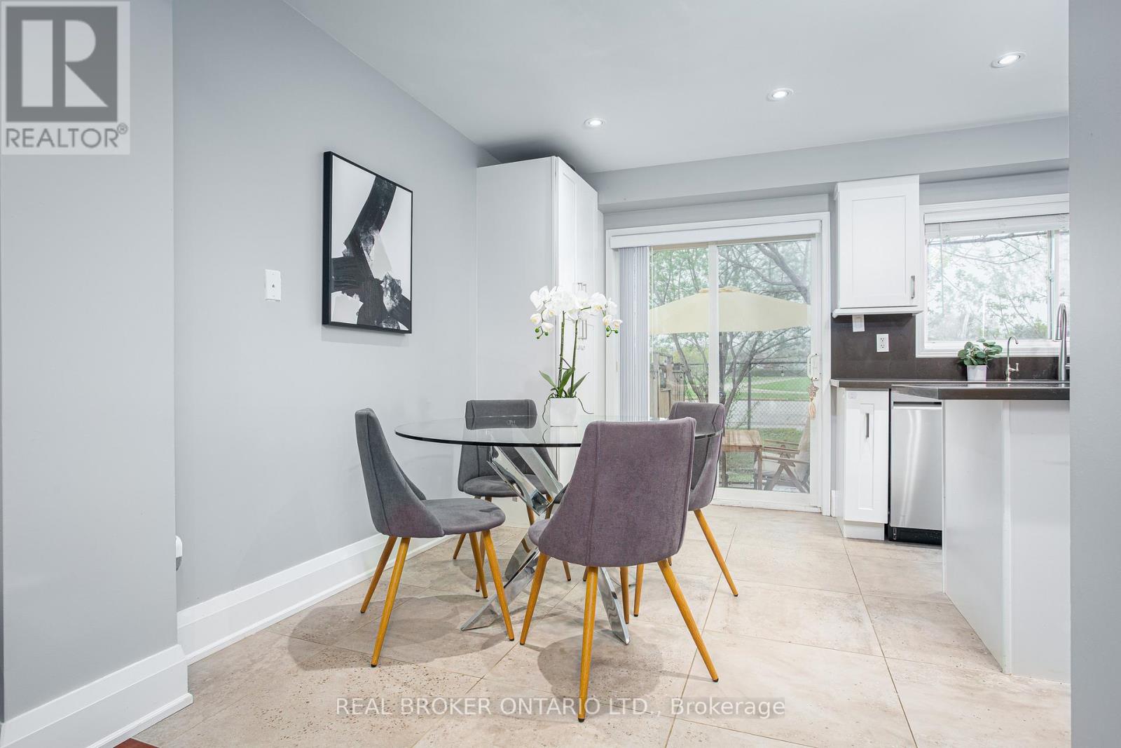 A dining room with a table and chairs.