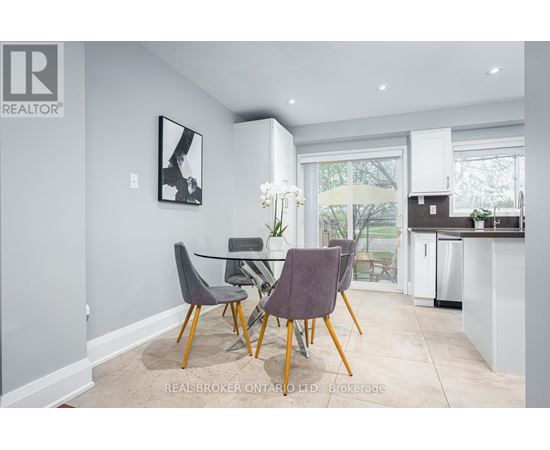 A dining room with a table and chairs.
