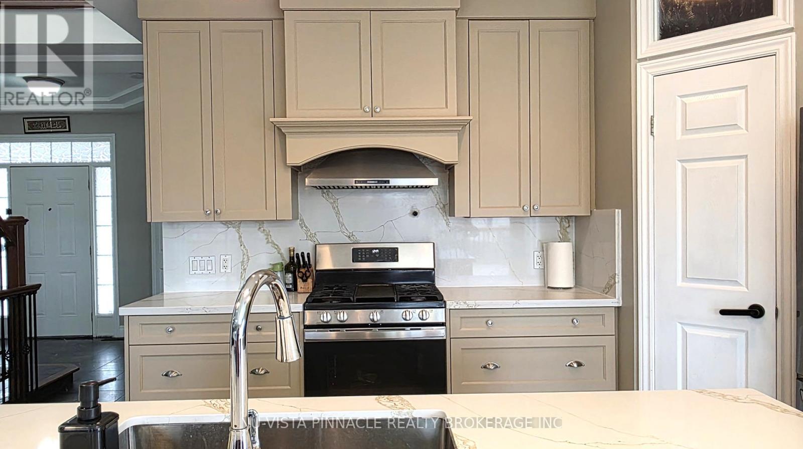 A kitchen with a stove top oven and a sink.