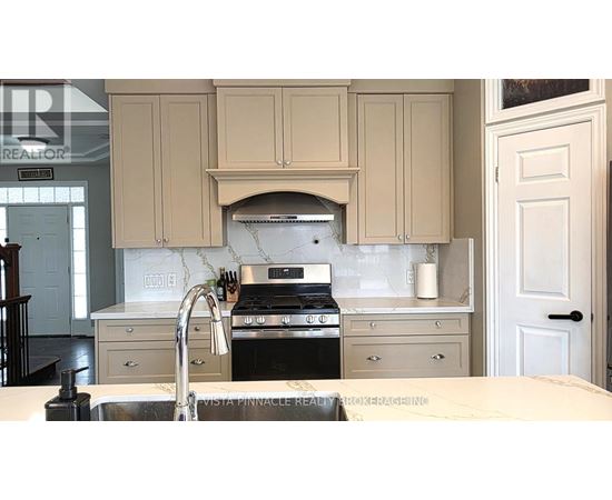 A kitchen with a stove top oven and a sink.