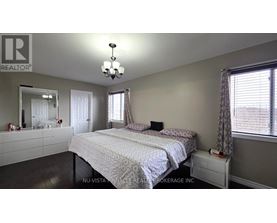 A bedroom with a large bed and a mirror on the wall.