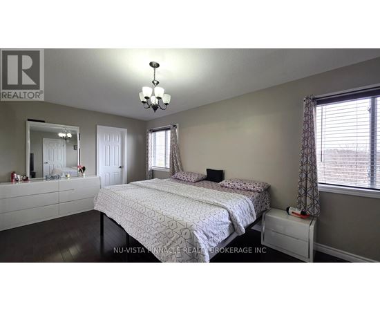 A bedroom with a large bed and a mirror on the wall.
