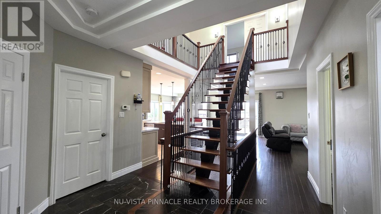 A spacious room with a staircase and a couch.