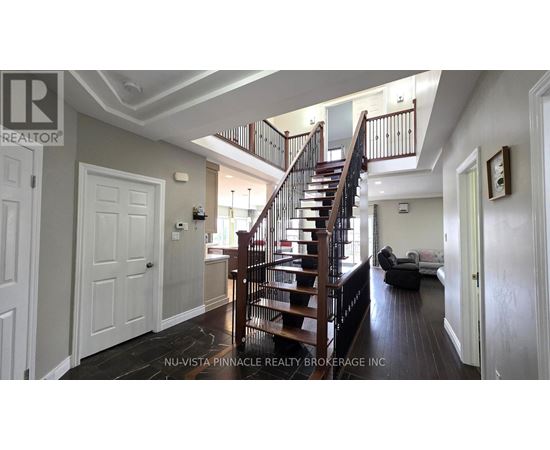 A spacious room with a staircase and a couch.