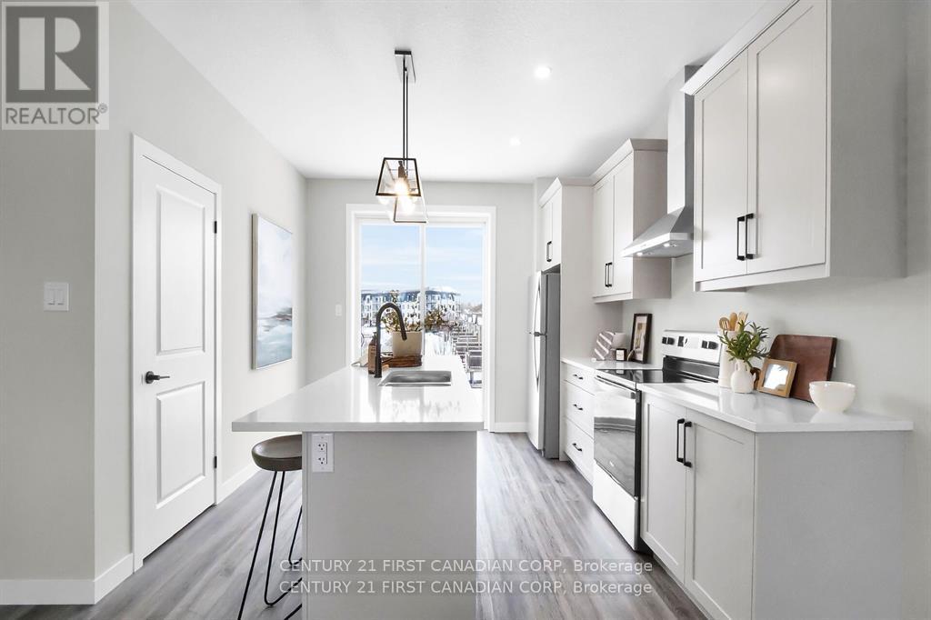 A modern kitchen with white cabinets and a large island.