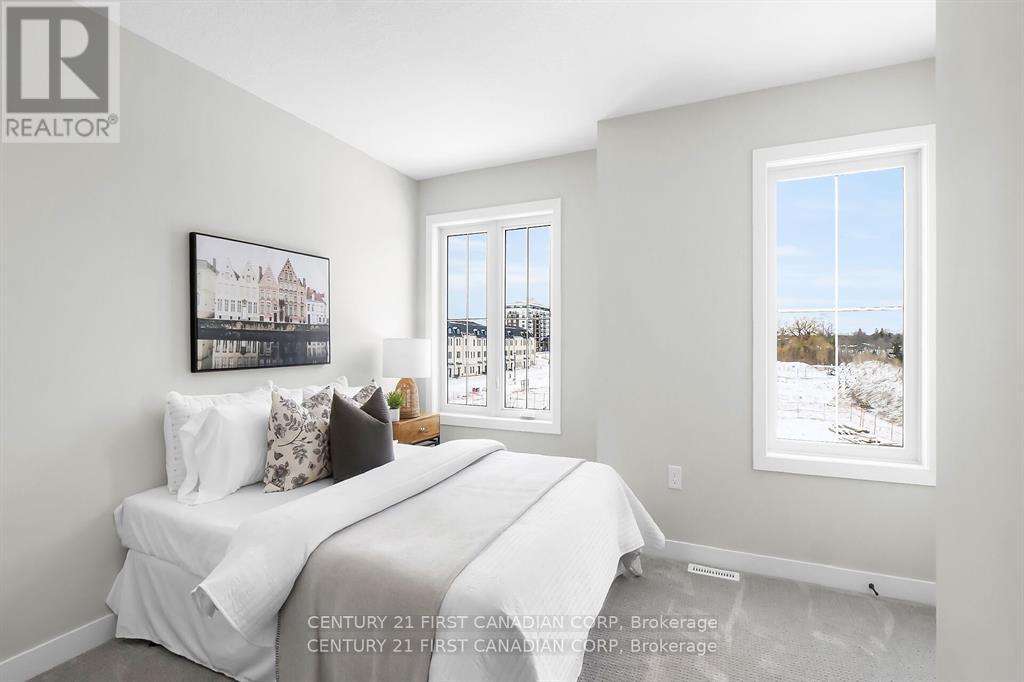 A bedroom with a large bed and a window showing a snowy landscape outside.