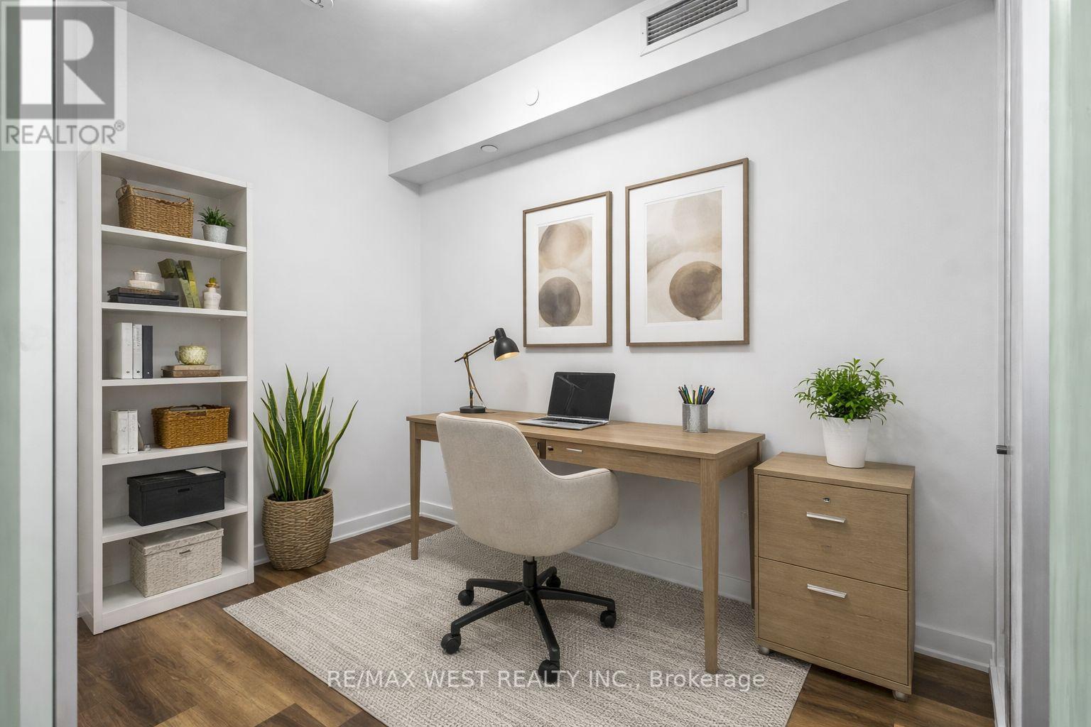 A well-lit office space with a desk, chair, and shelving unit.