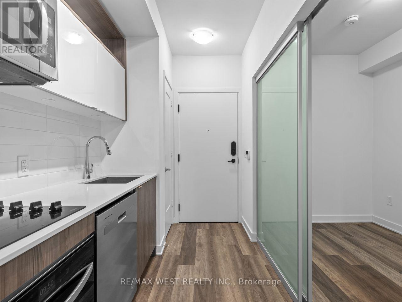 A kitchen with white cabinets and a glass door.