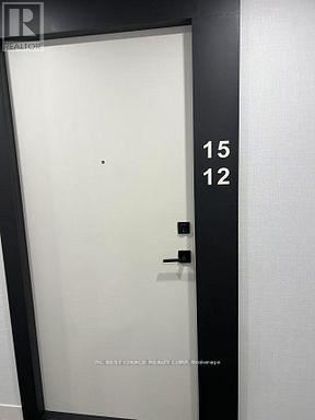 A black door with the numbers 15 and 12 on it.