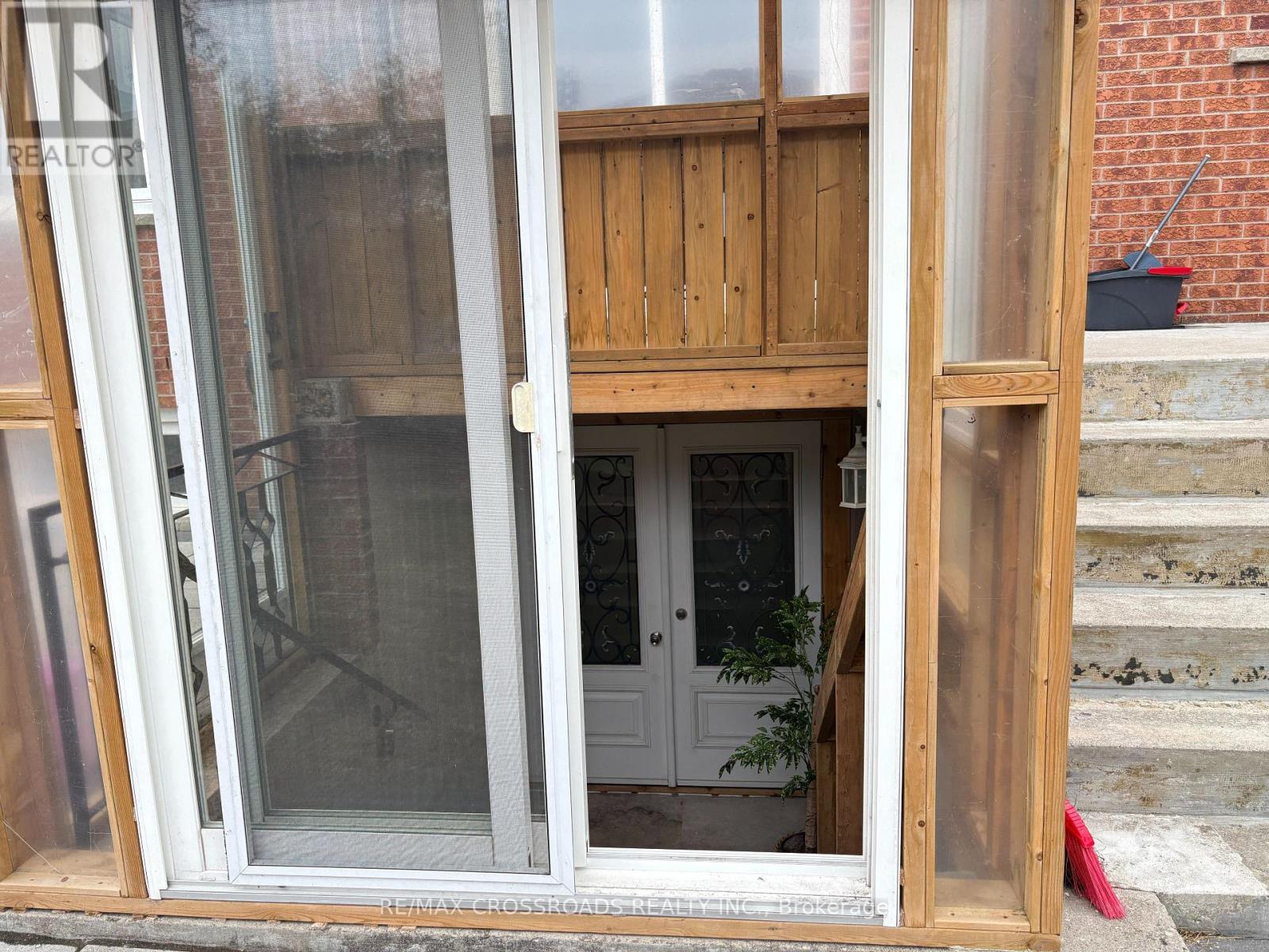 A white door is open to a room with a wooden interior.