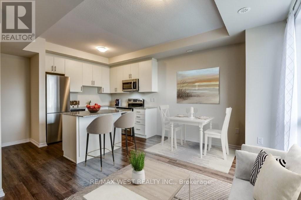 A modern kitchen with white chairs and a dining table.