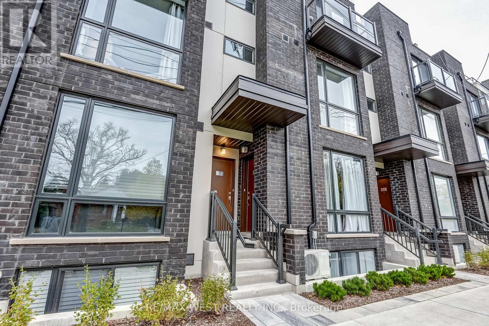 A modern apartment building with a mix of brick and panel exterior.