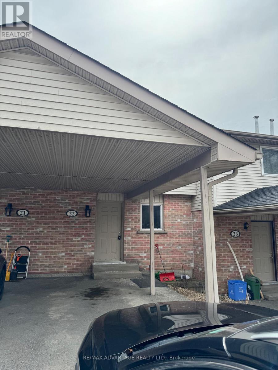 A house with a covered garage and a brick wall.