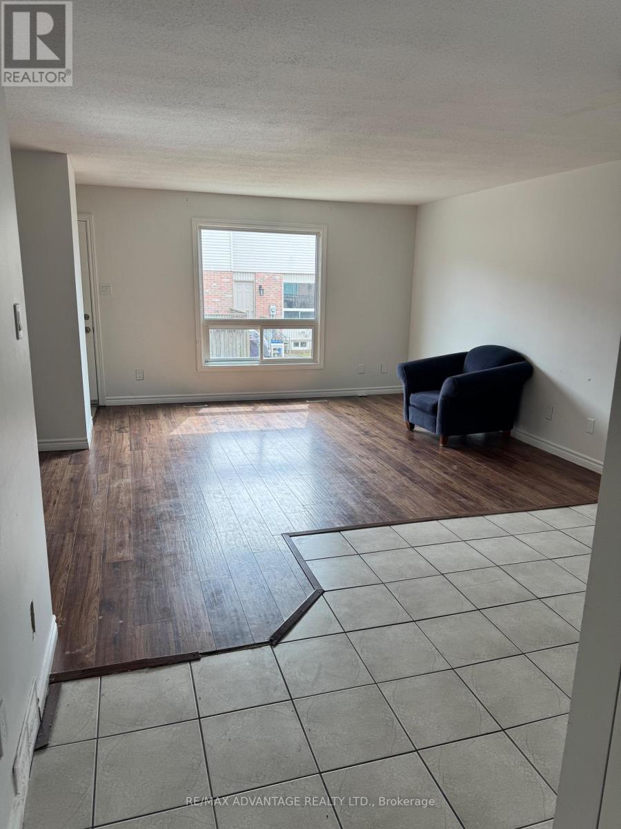 A room with a large window and a wooden floor.