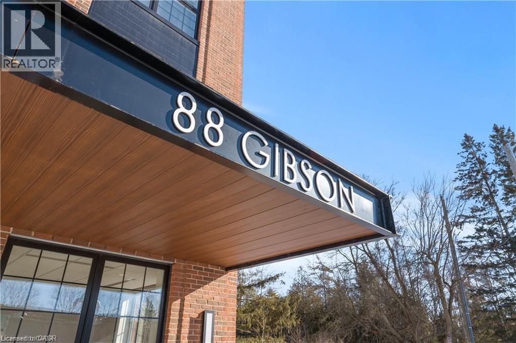 A building with a sign that reads "88 Gibson" in front of it.
