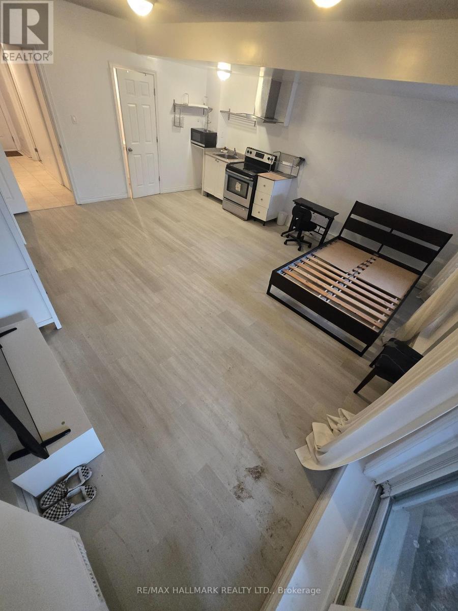 A bedroom with a bed, desk, and chair.