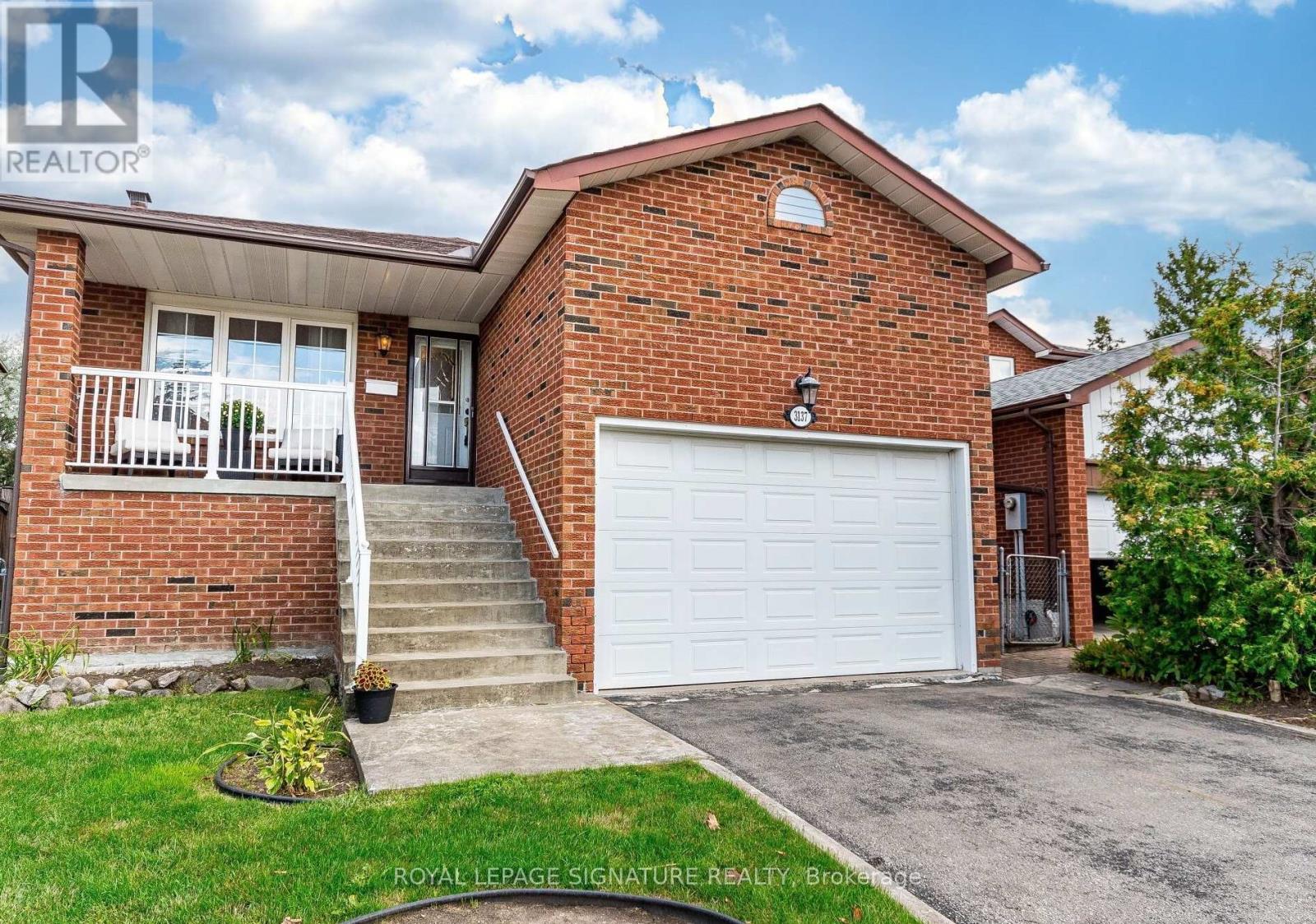 A house with a white garage door is for sale.