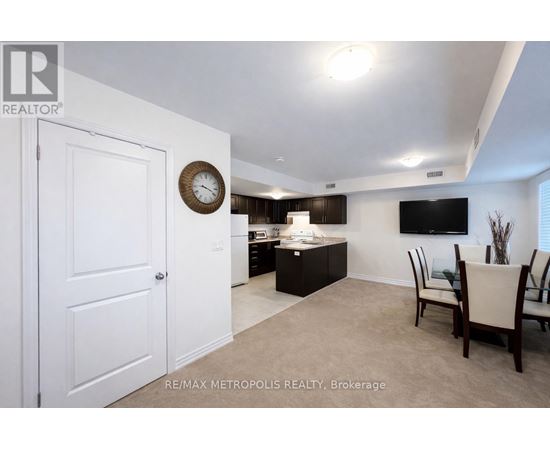 A living room with a white door and a clock on the wall.
