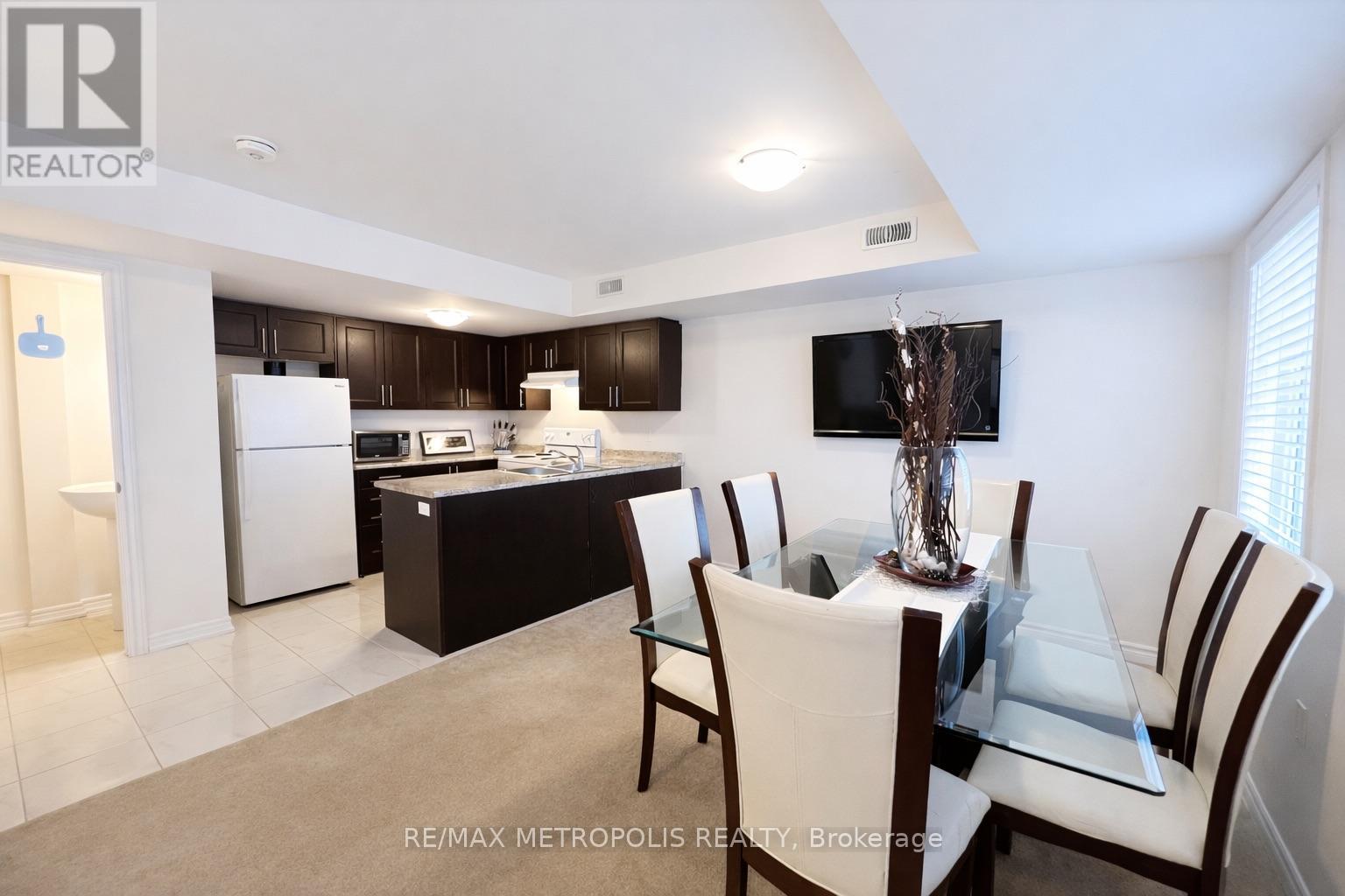 A modern kitchen with a dining table set for four.
