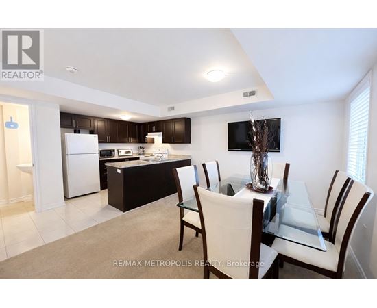 A modern kitchen with a dining table set for four.