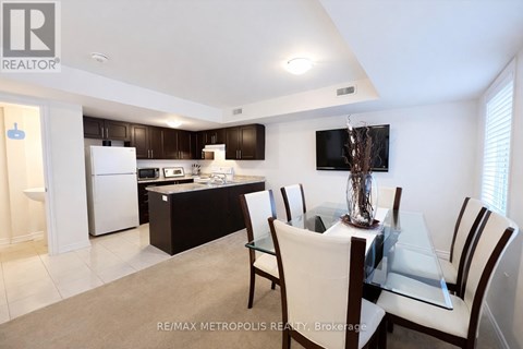 A modern kitchen with a dining table set for four.