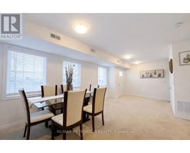 A dining room with a table and chairs.