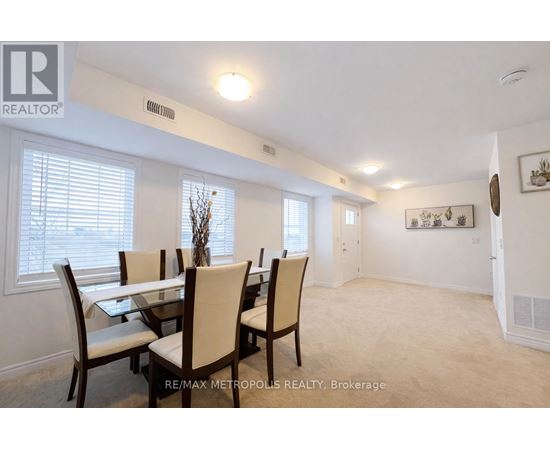 A dining room with a table and chairs.